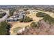 A panoramic aerial view showcases the golf course and surrounding residential neighborhood at 1037 Windermere Xing, Cumming, GA 30041