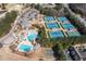Aerial view of community amenities: tennis courts, pools, clubhouse, parking, and basketball court at 1037 Windermere Xing, Cumming, GA 30041