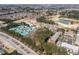 This aerial view features the community tennis courts, pool, and meticulously maintained landscaping at 1037 Windermere Xing, Cumming, GA 30041