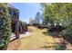 Expansive backyard with lush landscaping, a retaining wall and steps leading to a second story deck at 1037 Windermere Xing, Cumming, GA 30041