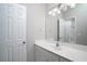 Bright bathroom with a large mirror, spacious vanity, and a shower and toilet in the background at 1037 Windermere Xing, Cumming, GA 30041