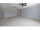 Large bedroom featuring plush carpet, neutral paint, and a ceiling fan perfect for relaxation at 1037 Windermere Xing, Cumming, GA 30041