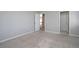 Bedroom featuring neutral walls, plush carpet, and doorway leading to additional rooms in the house at 1037 Windermere Xing, Cumming, GA 30041