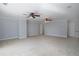 Large bedroom with carpet, ceiling fans, neutral paint, and entry doors at 1037 Windermere Xing, Cumming, GA 30041