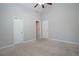 Spacious bedroom with neutral carpet, vaulted ceiling, and views into additional rooms at 1037 Windermere Xing, Cumming, GA 30041