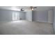 Large bedroom with light gray walls and double French doors at 1037 Windermere Xing, Cumming, GA 30041