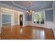 Formal dining room with hardwood floors, decorative molding, and elegant lighting at 1037 Windermere Xing, Cumming, GA 30041