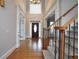 Spacious foyer featuring hardwood floors, a staircase, and a front door with large windows at 1037 Windermere Xing, Cumming, GA 30041