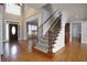 Grand foyer with hardwood floors, staircase with iron spindles, and high ceilings at 1037 Windermere Xing, Cumming, GA 30041