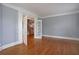 Open living area with hardwood floors, double doors, and blue walls at 1037 Windermere Xing, Cumming, GA 30041