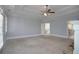Large living room features a fireplace, ceiling fan, crown molding, and neutral carpet at 1037 Windermere Xing, Cumming, GA 30041