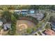 Aerial view showcasing community amenities including tennis courts, a pool, and a baseball field at 174 Vandiver Ct, Acworth, GA 30101