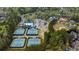 An aerial view shows tennis courts, swimming pool, parking lot, and ballfield situated among wooded residences at 174 Vandiver Ct, Acworth, GA 30101