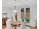 Bright breakfast nook with a modern light fixture, table and chairs, and sliding doors to the backyard at 174 Vandiver Ct, Acworth, GA 30101