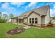 The rear exterior shows manicured grounds, stone walkway, and covered patio, blending comfort and natural beauty at 174 Vandiver Ct, Acworth, GA 30101
