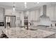 Beautiful kitchen features stainless steel appliances, granite countertops, and modern fixtures at 174 Vandiver Ct, Acworth, GA 30101