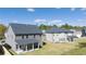 Exterior view of new homes showcasing well-maintained lawns and covered patios in a desirable community at 1821 Lacebark Elm Way, Lawrenceville, GA 30045