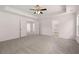 Expansive bedroom showcases a neutral palette, plush carpet, tray ceiling and multiple access points at 1821 Lacebark Elm Way, Lawrenceville, GA 30045