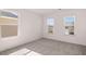 Bedroom with neutral walls and carpet featuring two windows that bring in natural light at 1821 Lacebark Elm Way, Lawrenceville, GA 30045