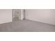 Spacious bedroom offers neutral walls and carpet, and has an open closet for organization at 1821 Lacebark Elm Way, Lawrenceville, GA 30045