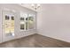 Bright dining area with hardwood floors, large window, and glass door access to outdoor space at 1821 Lacebark Elm Way, Lawrenceville, GA 30045