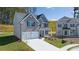 Charming two-story home with a gray brick facade, two-car garage, and neatly landscaped front yard at 1821 Lacebark Elm Way, Lawrenceville, GA 30045