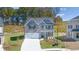 Beautiful gray brick home featuring a two-car garage and well-manicured lawn at 1821 Lacebark Elm Way, Lawrenceville, GA 30045