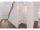 Welcoming foyer with hardwood floors, staircase, built-in bench, and convenient coat closet at 1821 Lacebark Elm Way, Lawrenceville, GA 30045
