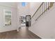 Bright, modern foyer features hardwood floors, a staircase with wrought iron railings, and an abundance of natural light at 1821 Lacebark Elm Way, Lawrenceville, GA 30045