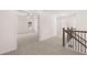Hallway leads to spacious room with a ceiling fan, bright window and neutral carpet throughout at 1821 Lacebark Elm Way, Lawrenceville, GA 30045