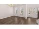 Spacious living room with beautiful hardwood floors, natural lighting, and a modern chandelier at 1821 Lacebark Elm Way, Lawrenceville, GA 30045