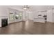 Open living space with a fireplace, hardwood floors, and access to a modern kitchen and backyard views at 1821 Lacebark Elm Way, Lawrenceville, GA 30045