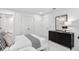 Bright bedroom with a dark wood dresser, white walls, and plush bedding at 5365 Julep Ct, Cumming, GA 30028