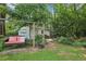 Tranquil backyard with mature trees and swing, 'find me on the patio' pillow at 5623 Crestwood Dr, Stone Mountain, GA 30087