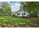 Spacious backyard with well-maintained lawn and the exterior of the home at 5623 Crestwood Dr, Stone Mountain, GA 30087
