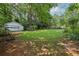 Expansive backyard featuring lush greenery and a detached garage, perfect for outdoor activities at 5623 Crestwood Dr, Stone Mountain, GA 30087