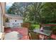 Back deck with outdoor seating overlooking a spacious, tree-filled backyard at 5623 Crestwood Dr, Stone Mountain, GA 30087
