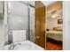 Bathroom with a glass shower, white sink, and open doorway to the bedroom at 5623 Crestwood Dr, Stone Mountain, GA 30087