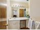 Bathroom with a white vanity, framed mirror, and doorway leading to a bedroom at 5623 Crestwood Dr, Stone Mountain, GA 30087
