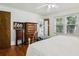 Bedroom featuring hardwood floors, a ceiling fan, and a large window at 5623 Crestwood Dr, Stone Mountain, GA 30087