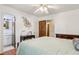 Bedroom with hardwood floors, white walls, ceiling fan and an attached bathroom at 5623 Crestwood Dr, Stone Mountain, GA 30087