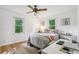Cozy bedroom with natural light, hardwood floors, and a ceiling fan at 5623 Crestwood Dr, Stone Mountain, GA 30087
