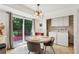 Sunny dining area with backyard access, a cozy table, and laundry closet at 5623 Crestwood Dr, Stone Mountain, GA 30087