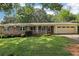 Charming brick ranch home with a well-maintained lawn and an attached garage at 5623 Crestwood Dr, Stone Mountain, GA 30087