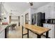 Bright kitchen with stainless steel appliances, a kitchen island, and access to laundry area at 5623 Crestwood Dr, Stone Mountain, GA 30087