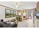 Open-concept living space featuring hardwood floors and seamless access to kitchen and outdoor deck at 5623 Crestwood Dr, Stone Mountain, GA 30087