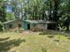 Charming brick home with a covered carport and lush, mature trees surrounding the property at 2890 Bianca Ct, Decatur, GA 30034