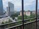 Balcony view showcasing the cityscape, including the Hyatt Place, with lush trees at 300 Peachtree St # Apt 9D, Atlanta, GA 30308
