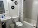 Bathroom featuring a vanity sink, toilet, and shower with white and gray patterned shower curtain at 300 Peachtree St # Apt 9D, Atlanta, GA 30308