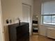 Bedroom boasting hardwood floors, a dark wood dresser, a full-length mirror, and a window with blinds at 300 Peachtree St # Apt 9D, Atlanta, GA 30308